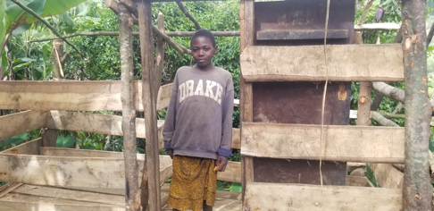 Elizabeth with her New goat shed before roofing